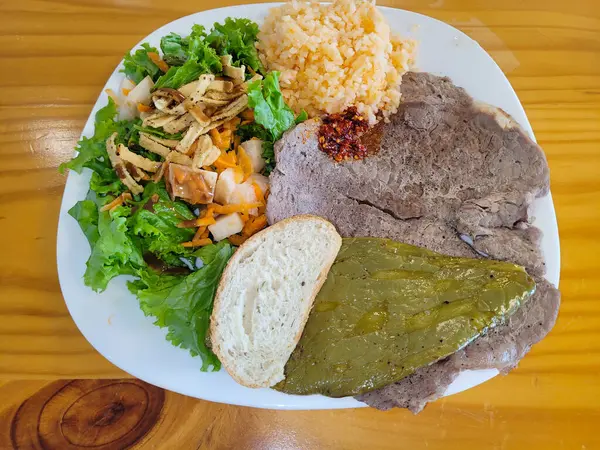 A balanced meal featuring a juicy grilled steak, baked potato, and a side of garden salad