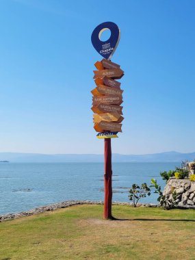 Chapala, Mexico - April 02 2023: A picturesque signpost with multiple arrows points to various destinations clipart