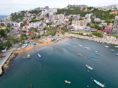 Expansive drone shot capturing the bustling atmosphere of Playa Manzanillo, nestled in Acapulcos scenic coastline clipart