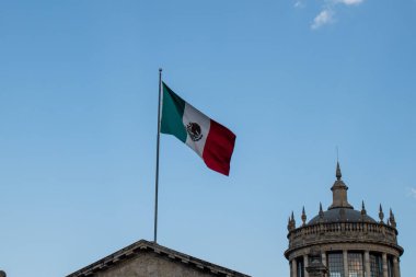 Guadalajara, Meksika - 2 Şubat 2025: Büyük Meksika bayrağı Guadalajara, Jalisco, Meksika 'da güneşli bir günde tarihi Cabanas kubbesi yakınlarında dalgalanmaktadır