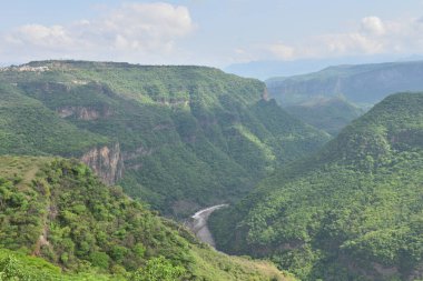 Breathtaking horizontal view of the lush Huentitan Canyon from the Viewpoint park, surrounded by greenery and scenic cliffs