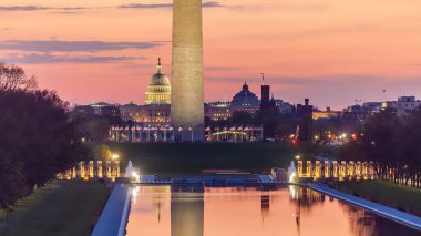Washington anıtı, güneş doğarken Washington, D.C. 'deki yansıtma havuzunda yansıtılıyor.