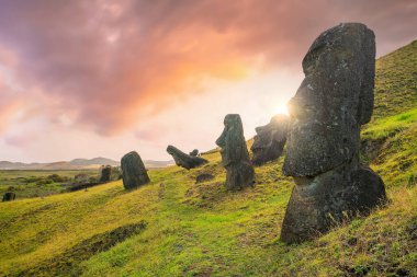 Paskalya Adası 'ndaki antik moai Şili sahilinin 2000 mil açığında gün batımında.