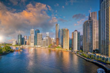 Brisbane city skyline and Brisbane river at sunset in Australia clipart