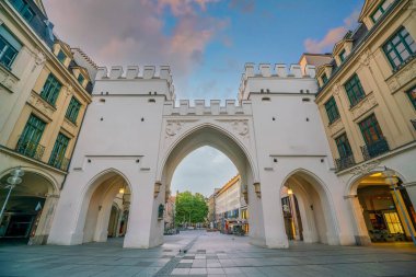 Ancient gate of Karistor in Munich, Germany at sunrise clipart