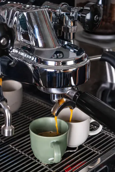 espresso machine filling two cups.