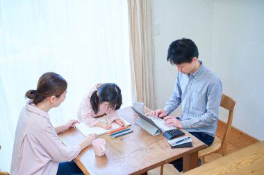 Anne ve kız oynuyor, resim yapıyor ve baba odada çalışıyor.