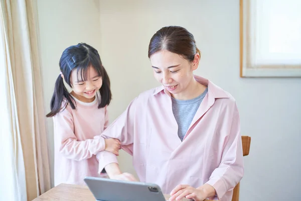 Girl Snuggling Her Mother Who Heading Computer Home — Stock Photo, Image