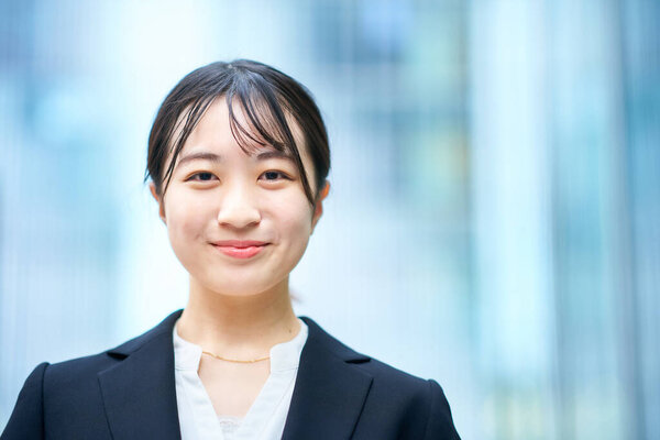 asian young woman in suit outdoors