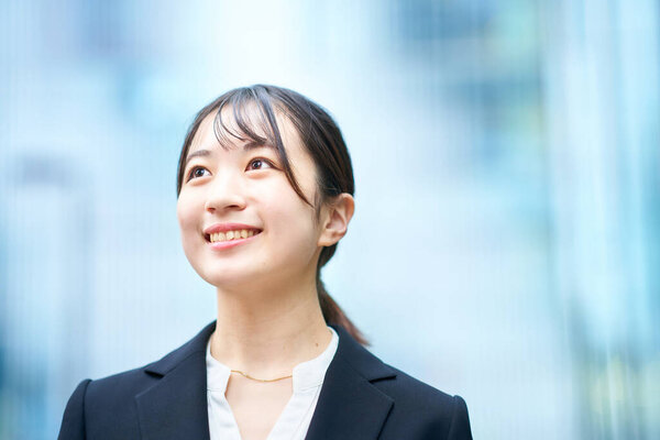 asian young woman in suit outdoors