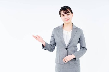 A woman in a suit posing for guidance and white background