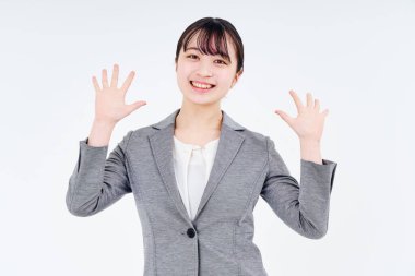 Young woman in a suit smiling and white background