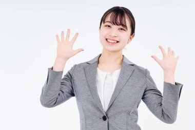 Young woman in a suit smiling and white background