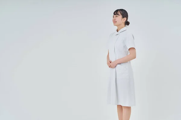Young Woman Wearing White Coat Indoors White Background — Stok fotoğraf