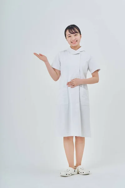Young Woman Wearing White Coat Indoors White Background — 图库照片