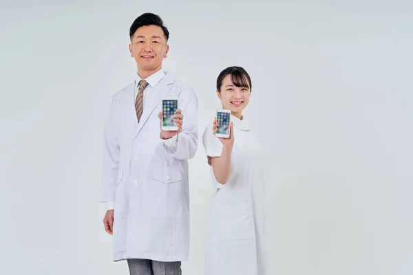 Man Woman Wearing White Coats Operating Smartphones White Background — Foto Stock