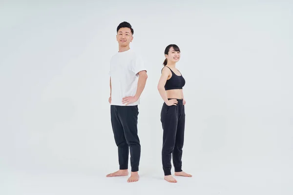 man and woman in sportswear and white background