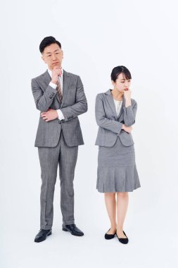 A man and woman in a suit who poses a question and white background