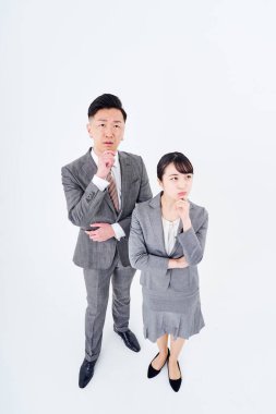 A man and woman in a suit who poses a question and white background