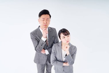 A man and woman in a suit who poses a question and white background