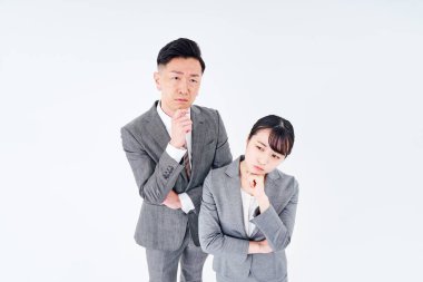 A man and woman in a suit who poses a question and white background