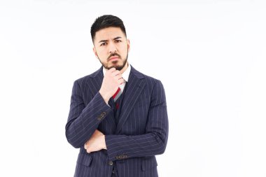 A man in a suit posing in thought and white background