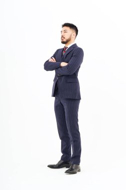 A man in a suit standing in front of a white background