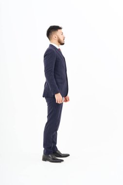 A man in a suit standing in front of a white background