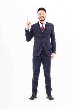 A man in a suit posing with his index finger up and white background