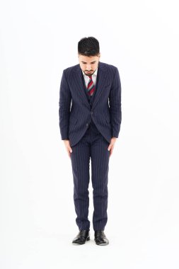 A man in a suit who poses to apologize and white background