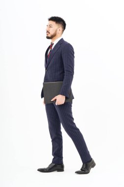 A man in a suit standing in front of a white background