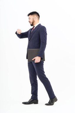 A man in a suit standing in front of a white background