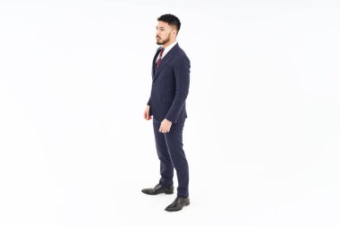 A man in a suit standing in front of a white background