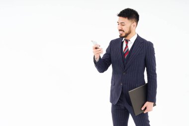 A man in a suit operating a smartphone and white background