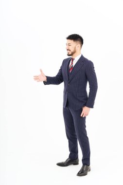 A man in a suit asking for a handshake and white background