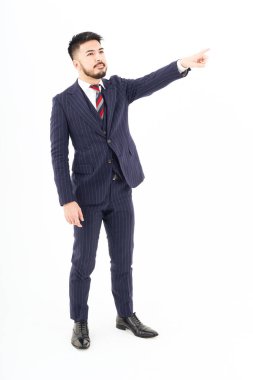 A man in a suit pointing up and white background