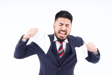 A man in a suit tearing up materials and white background