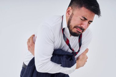 A man in a suit with a stressed expression with his clothes messed up