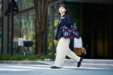 İşe gidip gelen ya da güzel bir günde dışarı çıkan genç bir kadın.