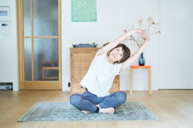 asian woman stretching in the room