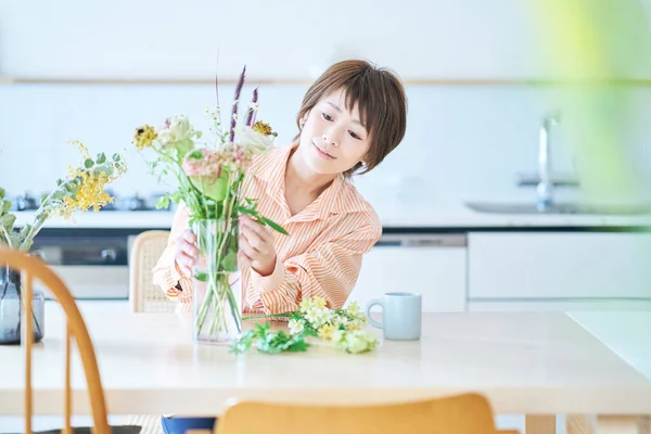 Wanita Mengatur Bunga Dengan Vas Bunga Dalam Ruangan — Stok Foto