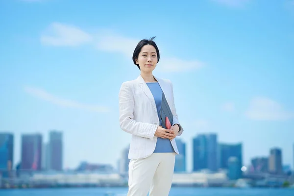 Stock image Business woman standing outdoors on fine day     