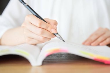 close up of a woman's hand studying with text clipart