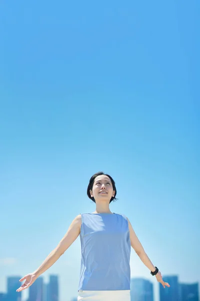 stock image A woman with a relaxed expression under the blue sky