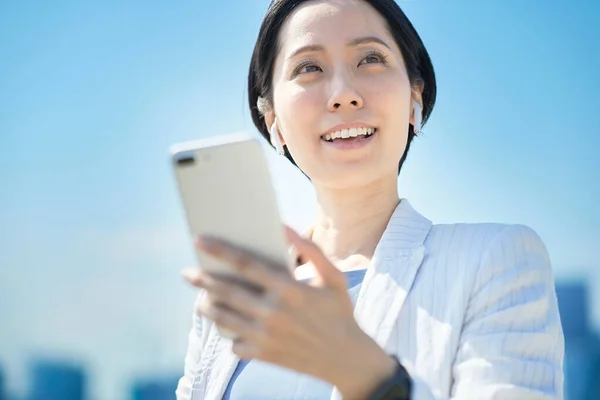 Asian Woman Holding Smartphone Outdoors — Stock Photo, Image