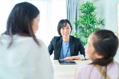 Conversation scene of a woman in a suit with a parent and child in the room clipart