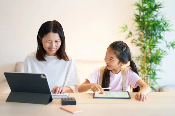 Girl Playing Woman Who Works Using Tablet Home — Stock Photo, Image