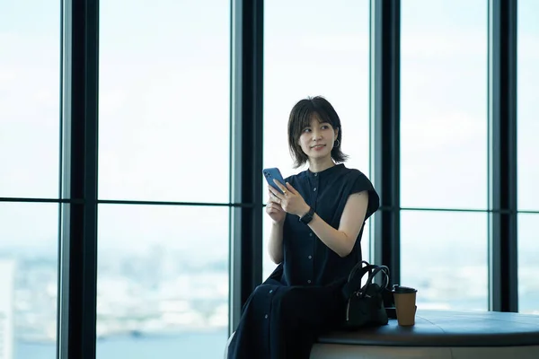 Asyalı Genç Bir Kadın Elinde Akıllı Telefon Tutuyor — Stok fotoğraf