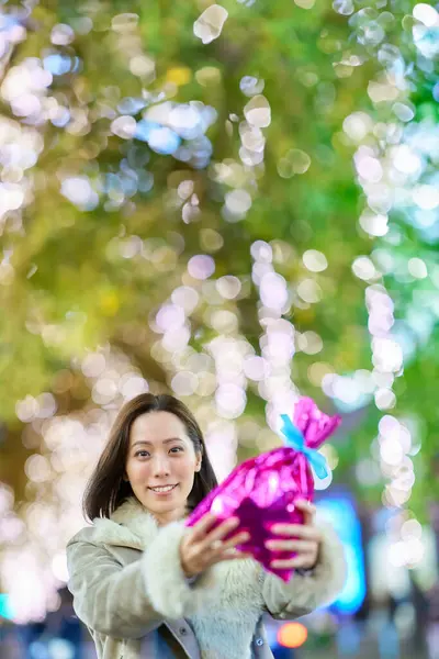 Woman Holding Colorfully Wrapped Present Outdoors Night — Stock Photo, Image