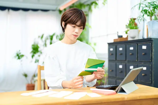Young Woman Looking Her Bankbook Indoors — Stock Photo, Image